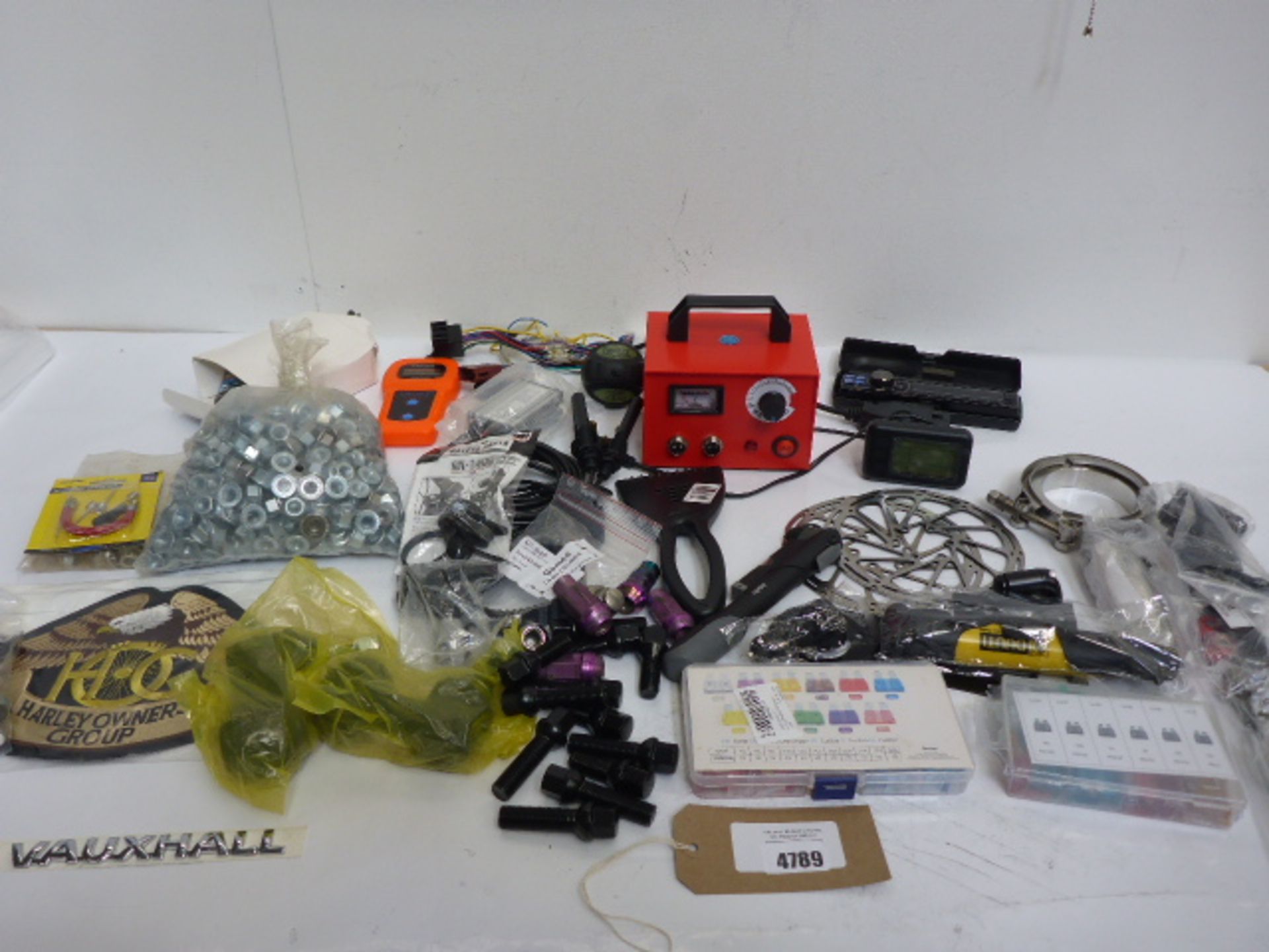 Bike sprockets, Harley Davidson badge, car reflectors, large bag of assorted nuts, belts, small