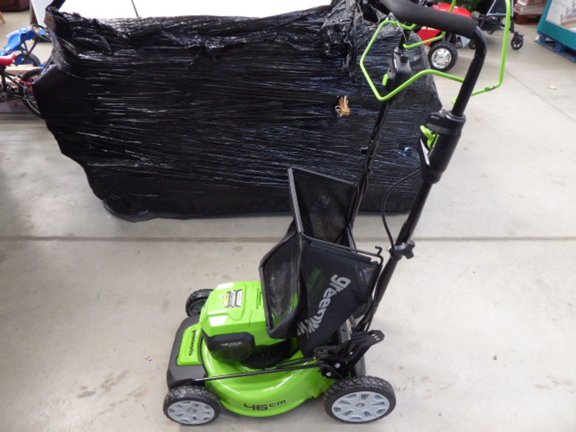 Greenworks battery powered lawn mower in green with grass box