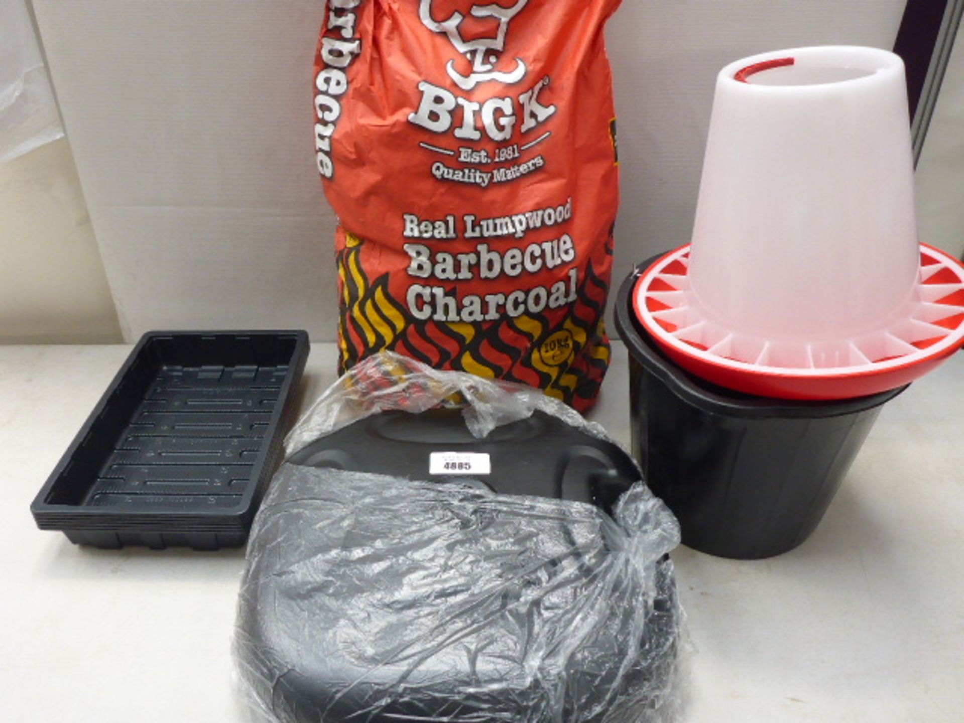Bag of barbecue charcoal, parasol base, seed trays, bucket and chicken feeder