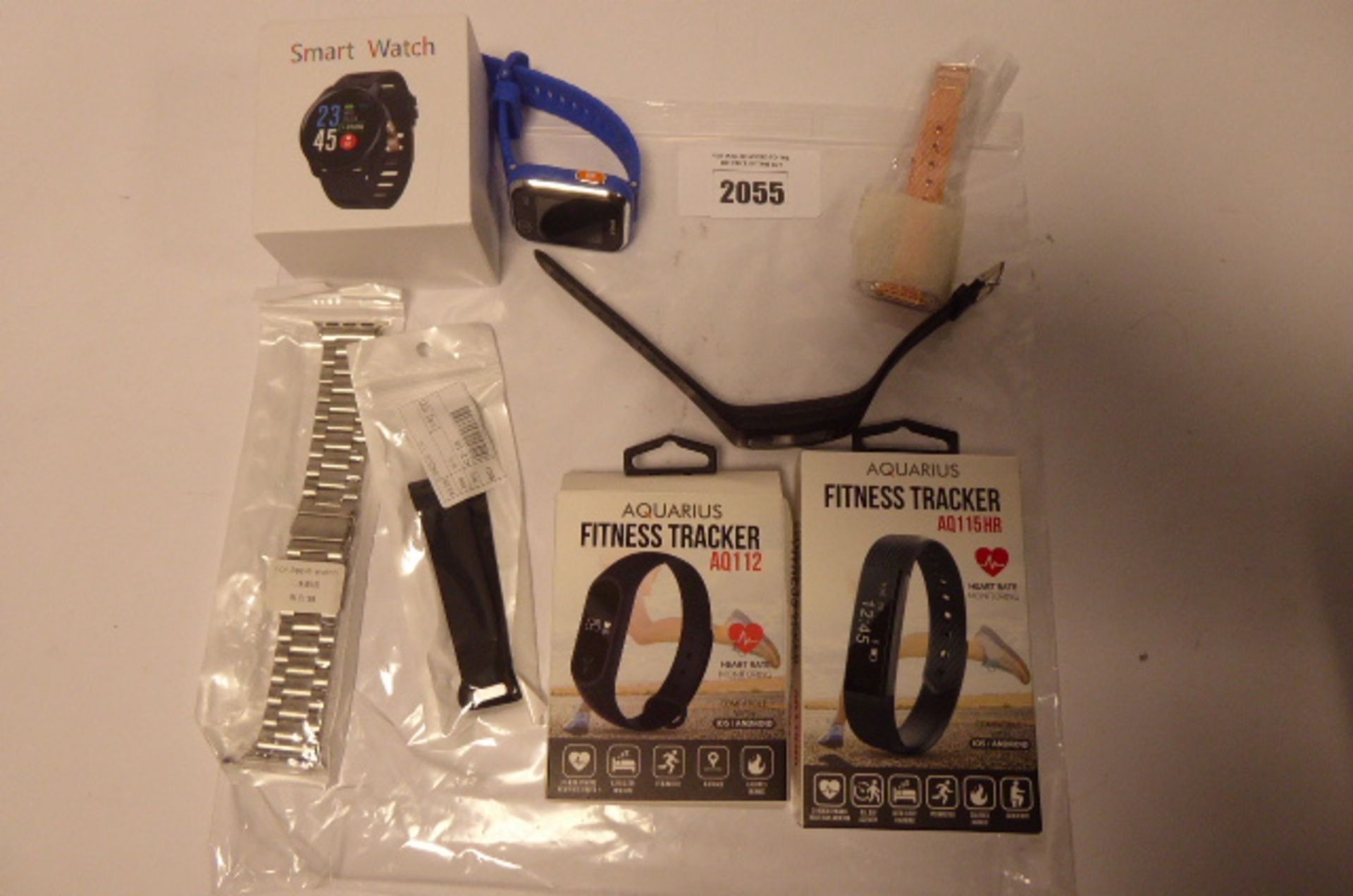 Bag of various activity tracking wristbands, some boxed.