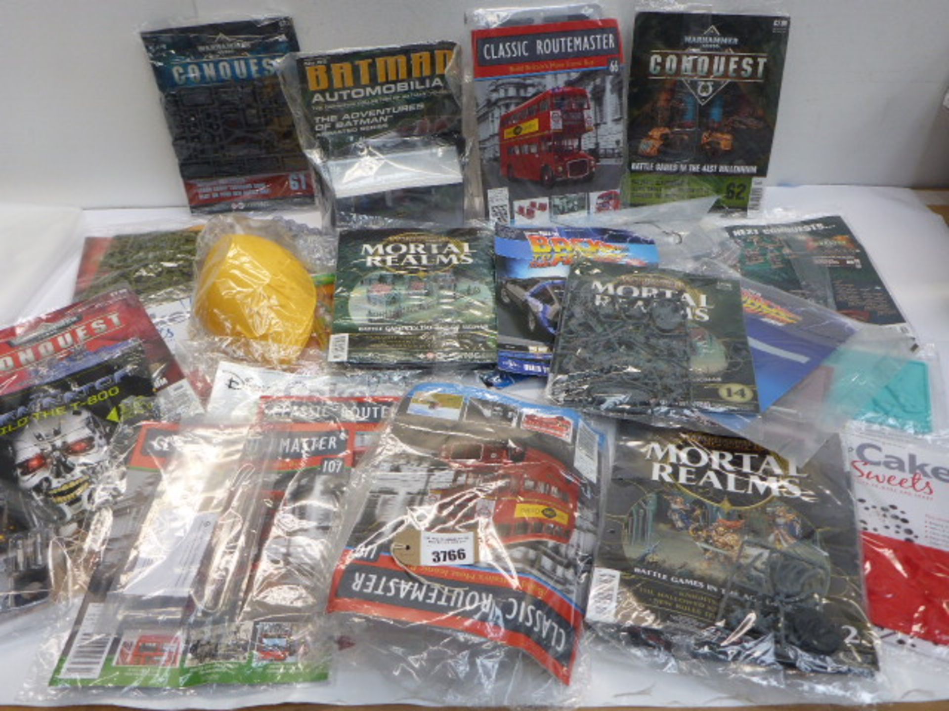 Selection of collectable magazines and model parts including Batman, Warhammer, Terminator, Disney