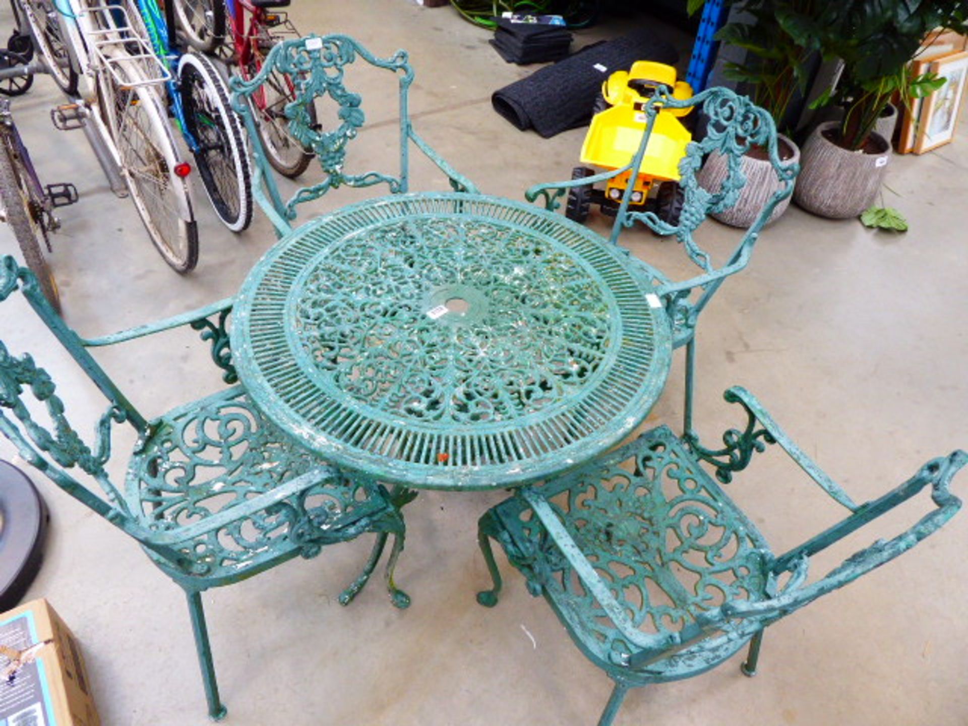 Green metal round garden table and 4 matching chairs