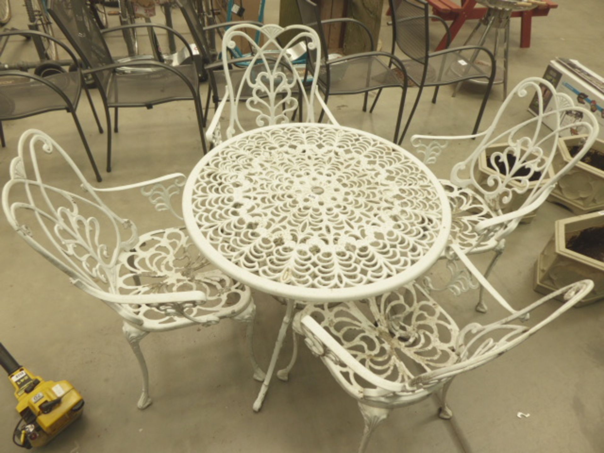 White 4 piece garden set consisting of 4 chairs and a metal table