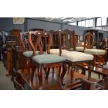 Three Edwardian oak framed dining chairs and a set of four balloon back dining chairs