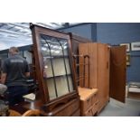 A wall mounted mahogany corner cabinet