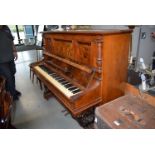 A walnut cased overstrung upright piano