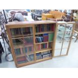 Glazed oak double door bookcase with a qty of encyclopedia and novels