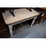 A stripped pine kitchen table with painted legs and single drawer