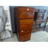 A walnut four drawer filing cabinet