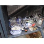 A cage of blue and white china, ornamental figures, decanter, wine glasses etc.