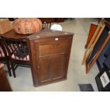 An oak corner cabinet