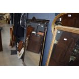 An early 20th century overmantel mirror in a gilt decorated ebonised framed