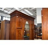 An Edwardian inlaid mahogany single wardrobe with drawer under