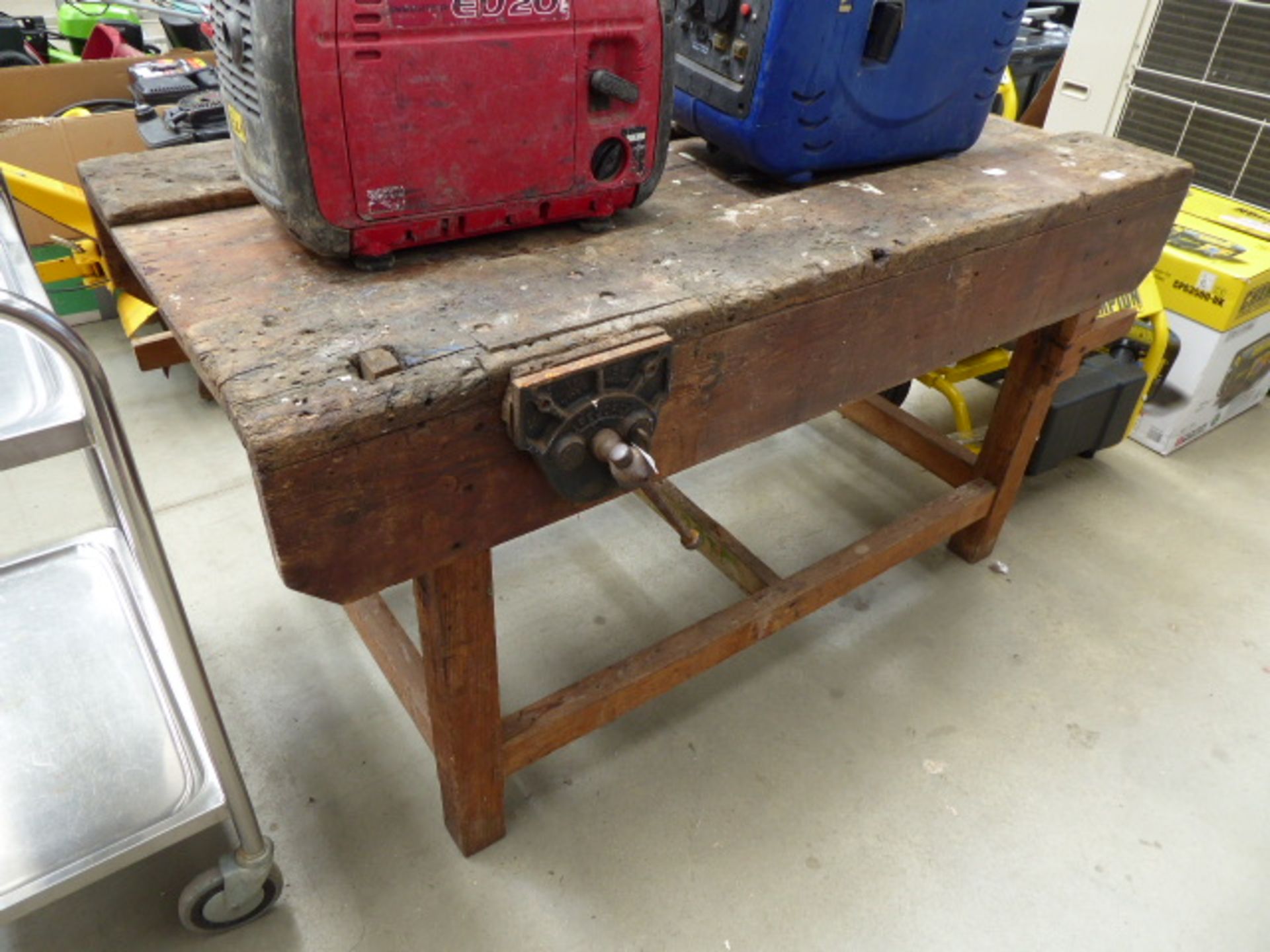 Large wooden workbench with vice