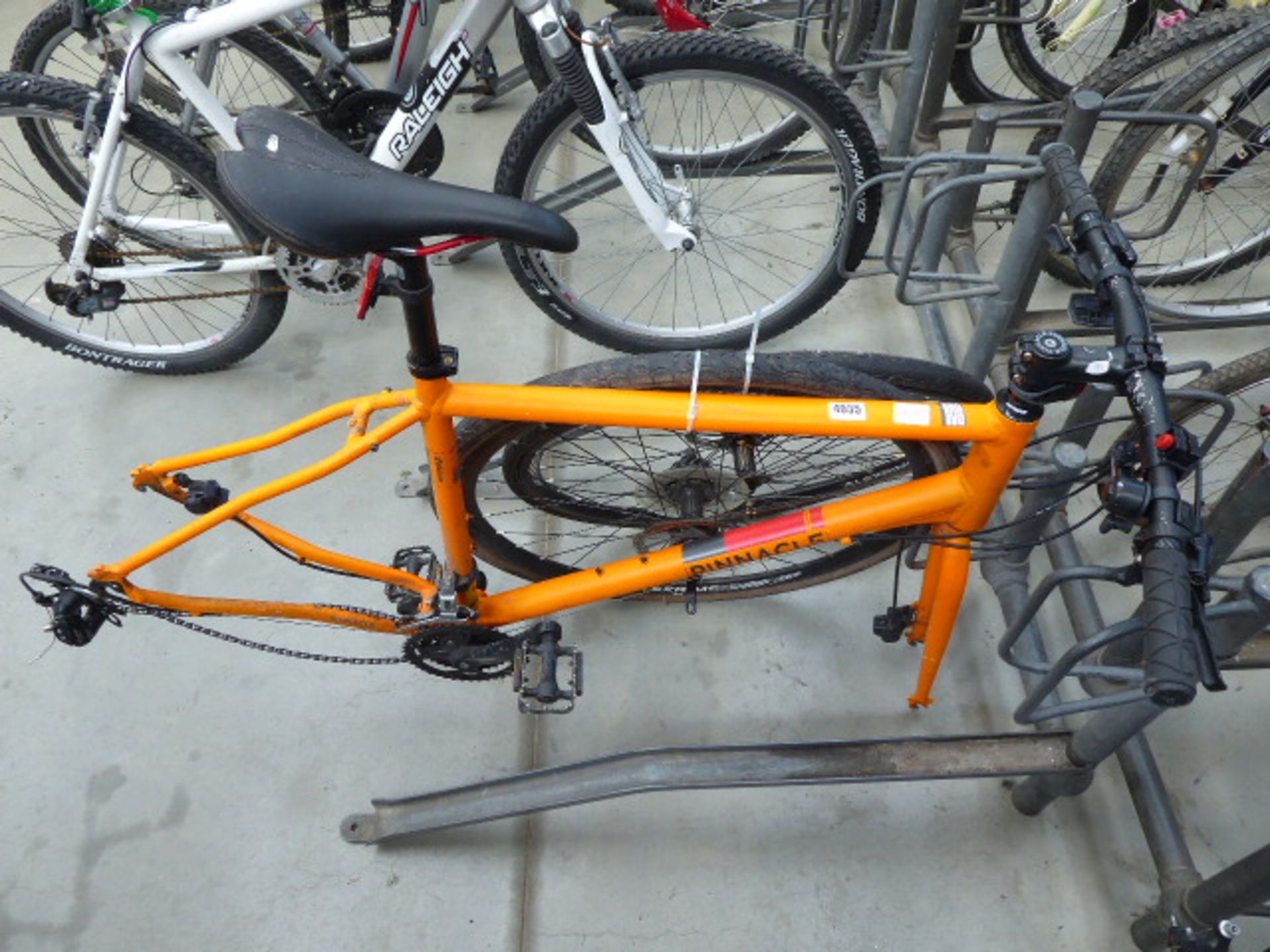 Orange Pinnacle cycle frame with 2 wheels
