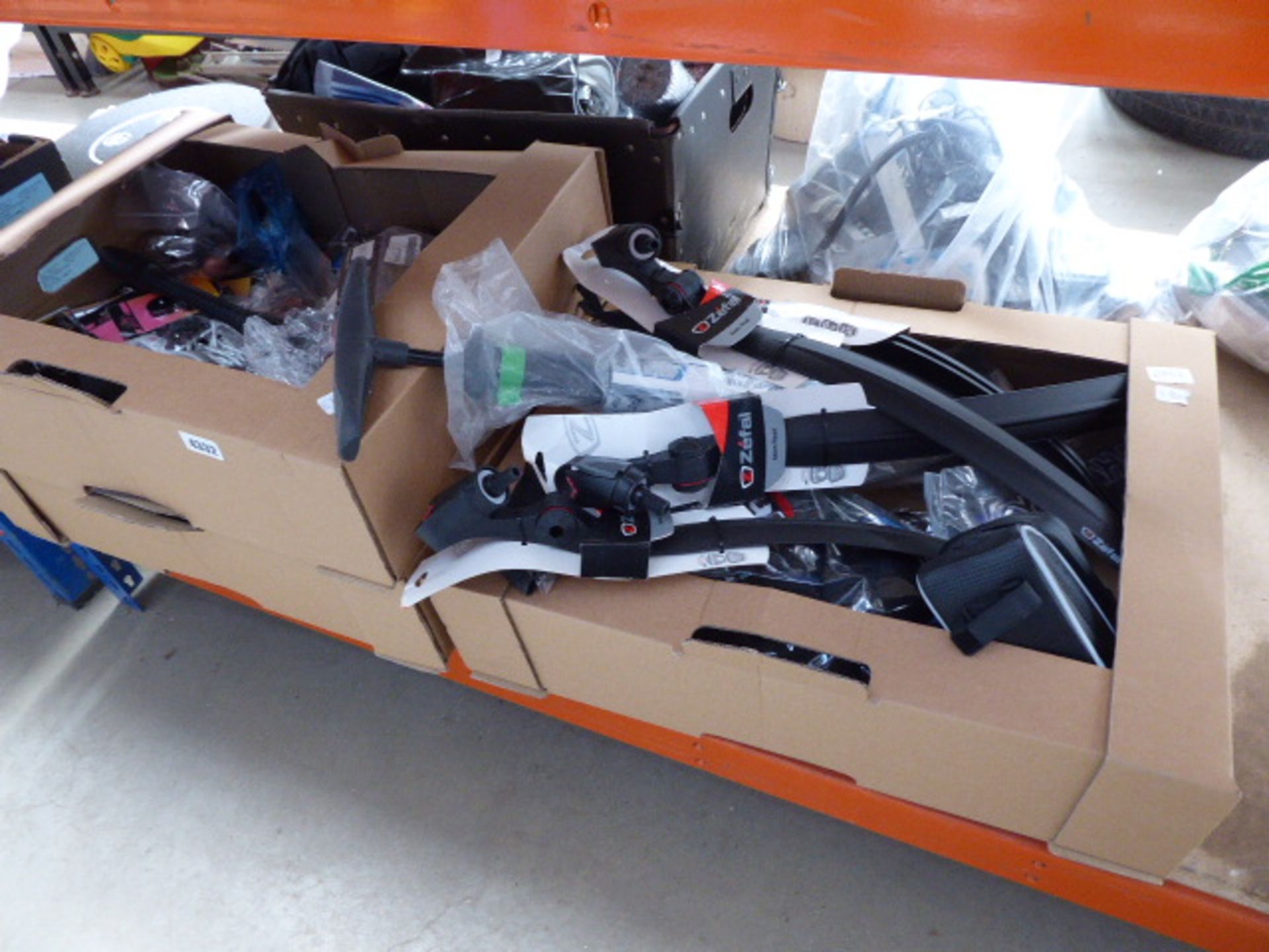 3 cardboard boxes containing bike parts inc. phone holders, mud guards, pumps and other parts inc.