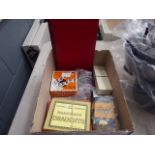 Box containing cards and board game pieces