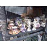Cage containing floral patterned cups and saucers,