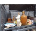 Cage containing a Nao style figure, amber glass bottle, ornaments,