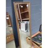 Narrow rectangular bevelled mirror in gilt frame