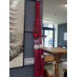 Pair of red fabric curtain tie backs
