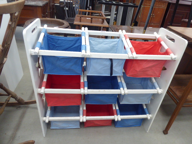 White painted child's toy rack with canvas baskets