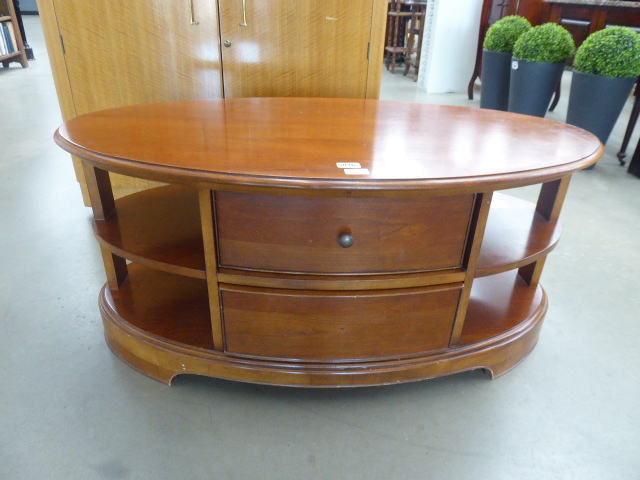 Oval coffee table/TV stand with drawers and shelves