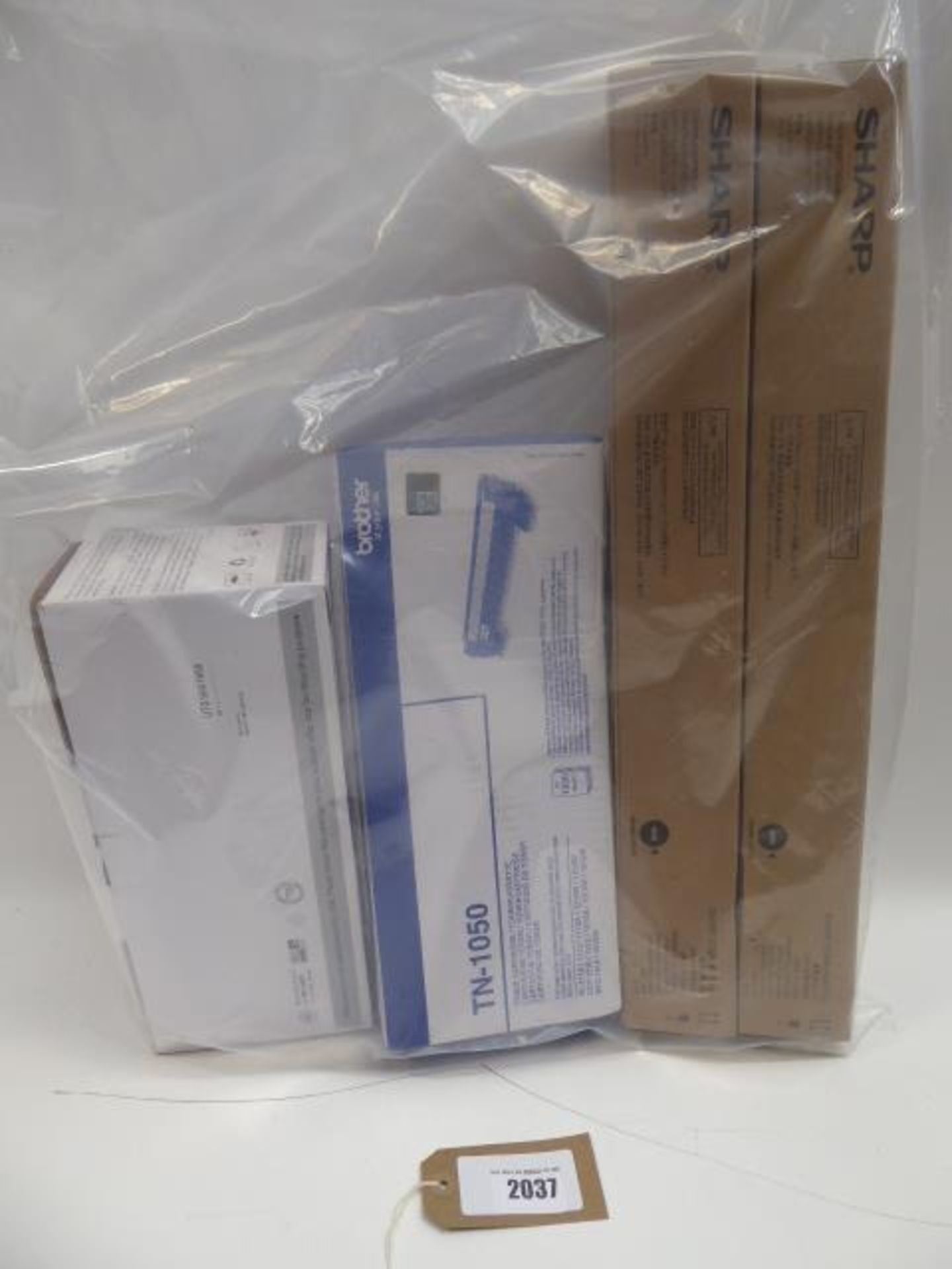 Bag containing toner cartridges for Sharp, Brother and one other