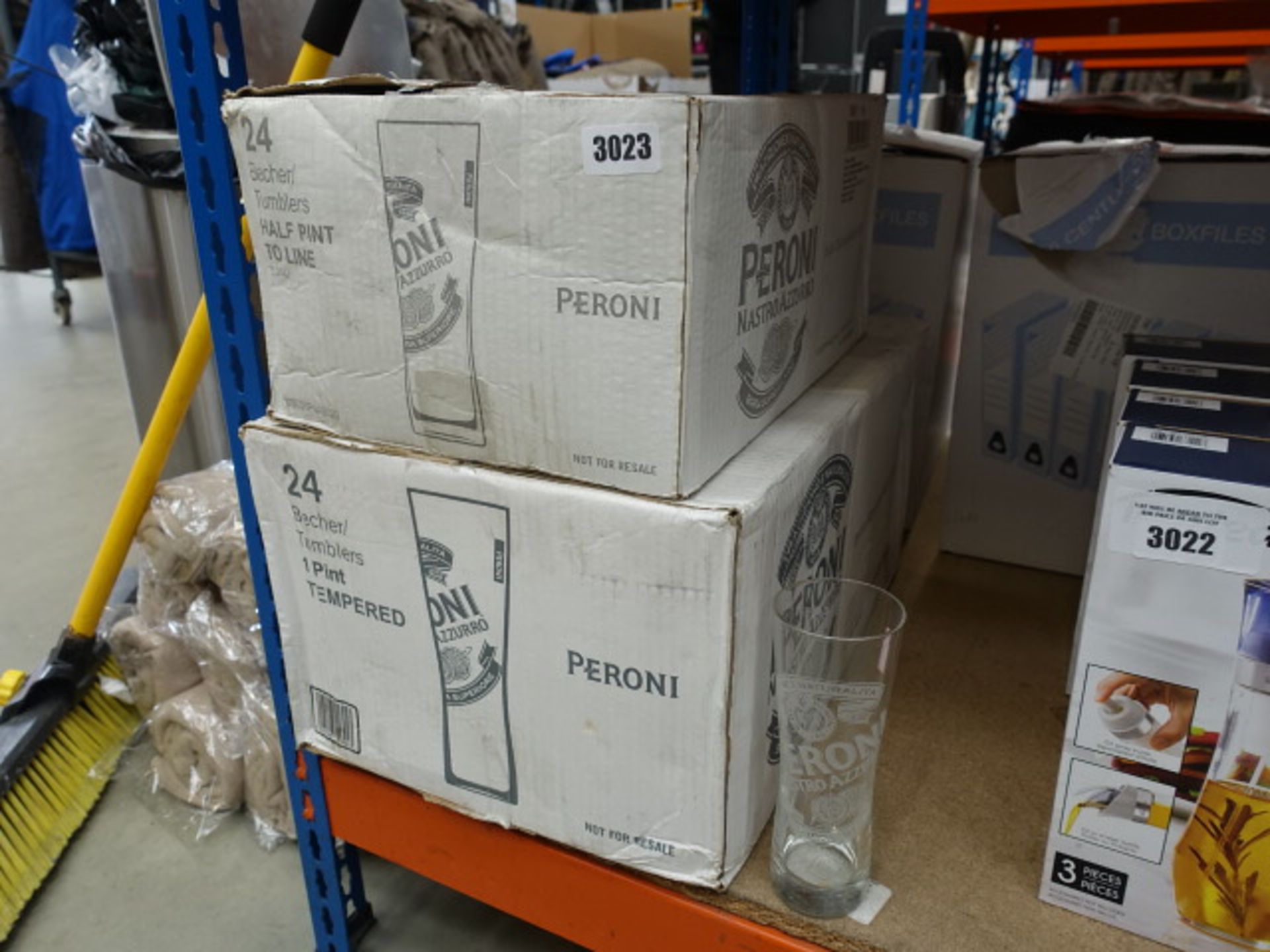 2 boxes containing pint and half pint Peroni glasses