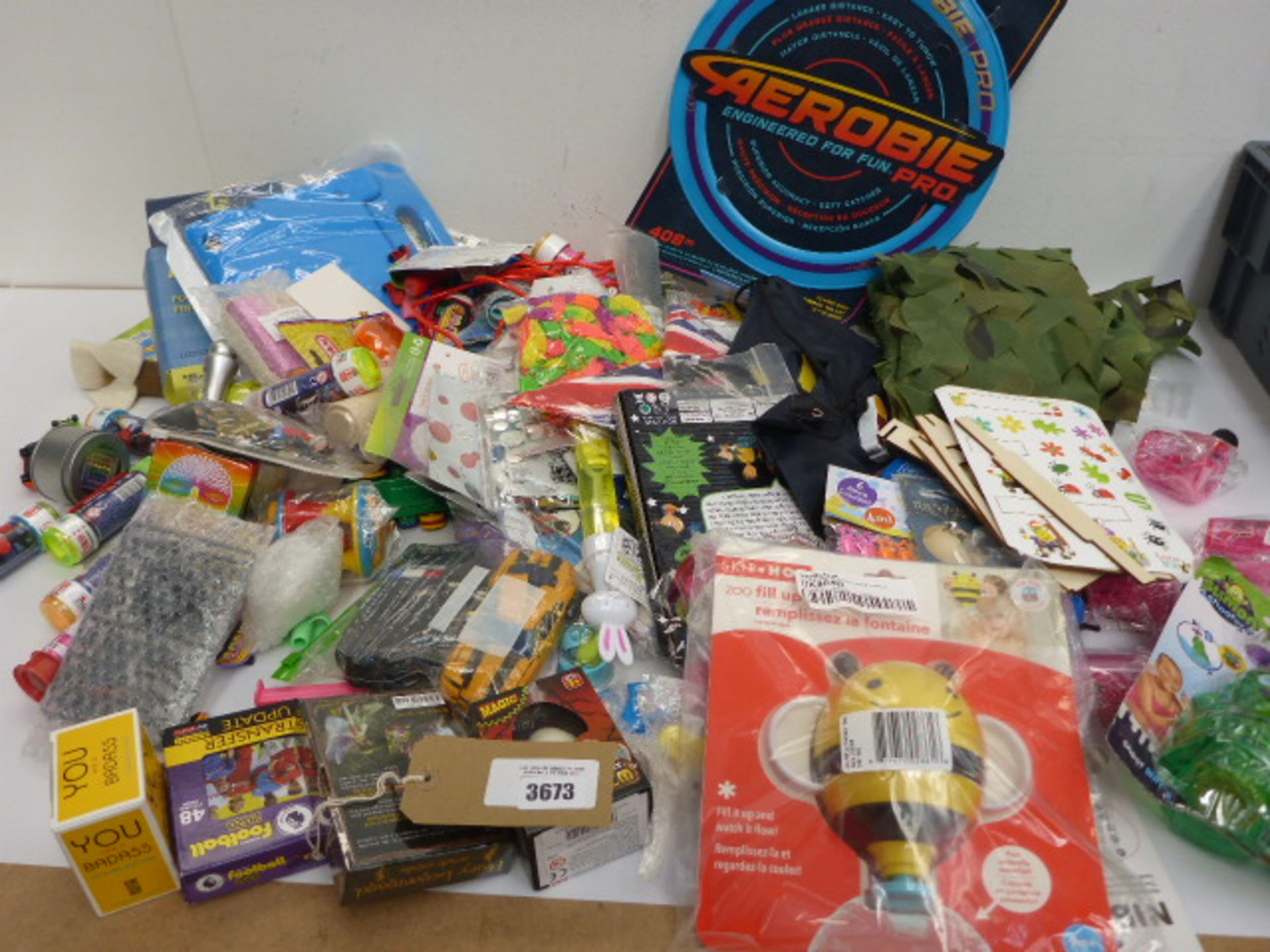 Large bag of novelty toys, card games, iPad sleeve, balloons, toy cars etc