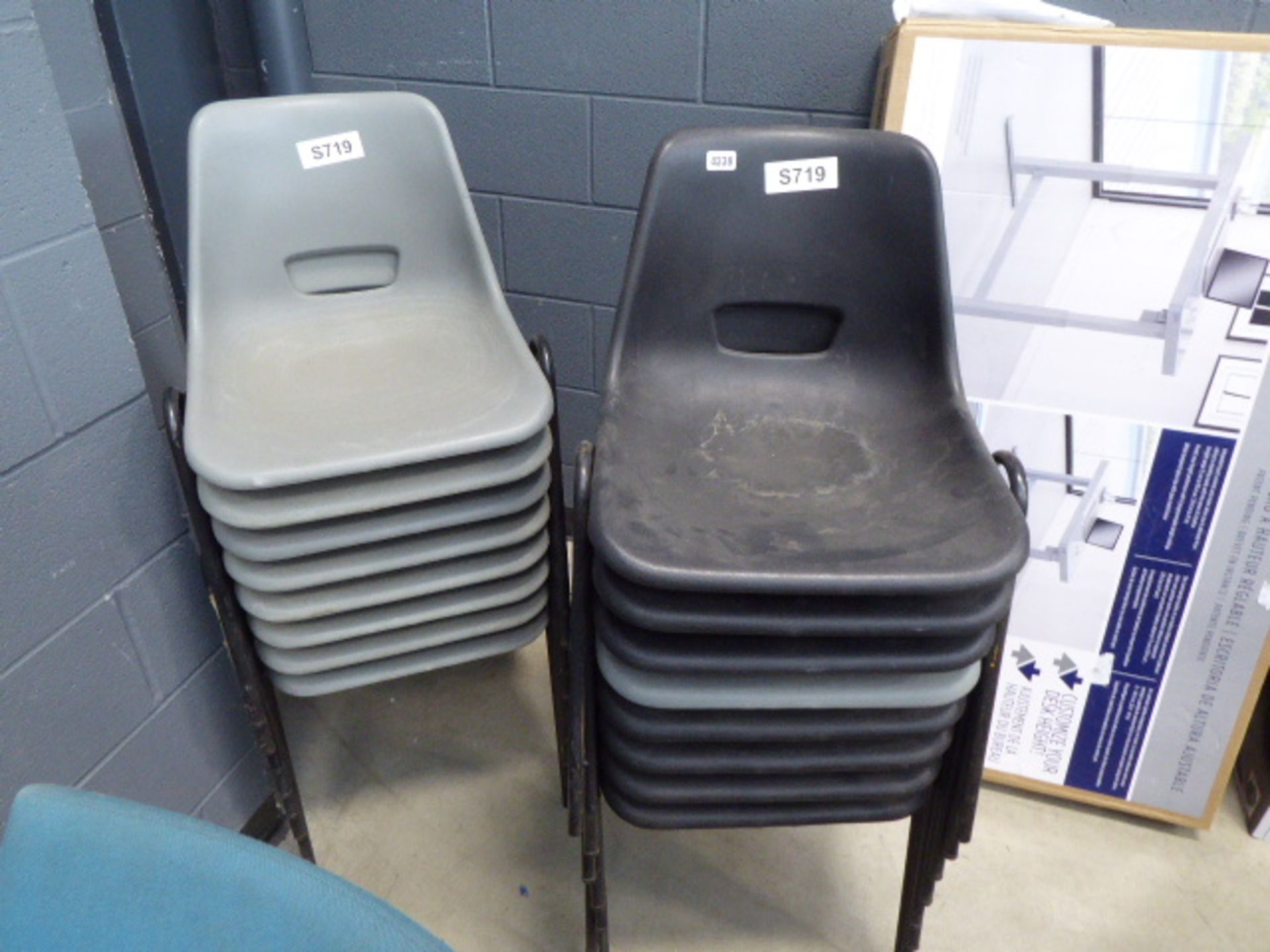 16 grey and black plastic stacking chairs