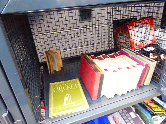 Cage containing the works of Winston Churchill and a book on English cricket