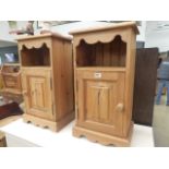 A pair of pine single door bedside cupboards