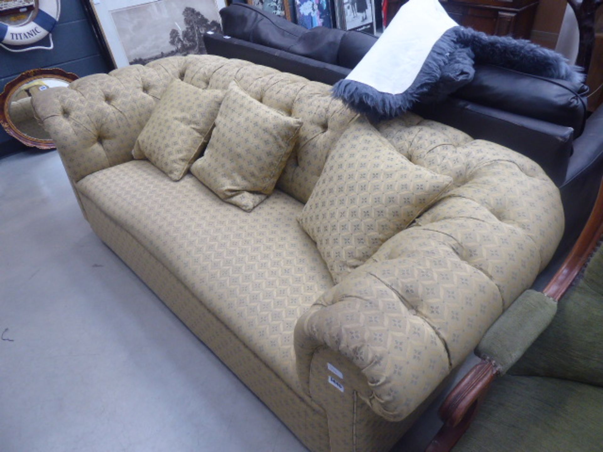 Gold floral patterned button-backed sofa