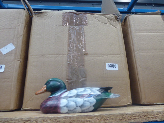 Box containing a quantity of painted wooden ducks