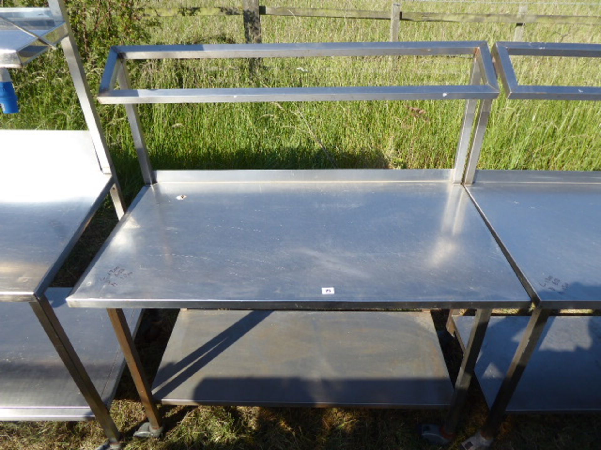 Stainless steel mobile food preparation station with a sloped shelf for Gastronorm pots and shelf