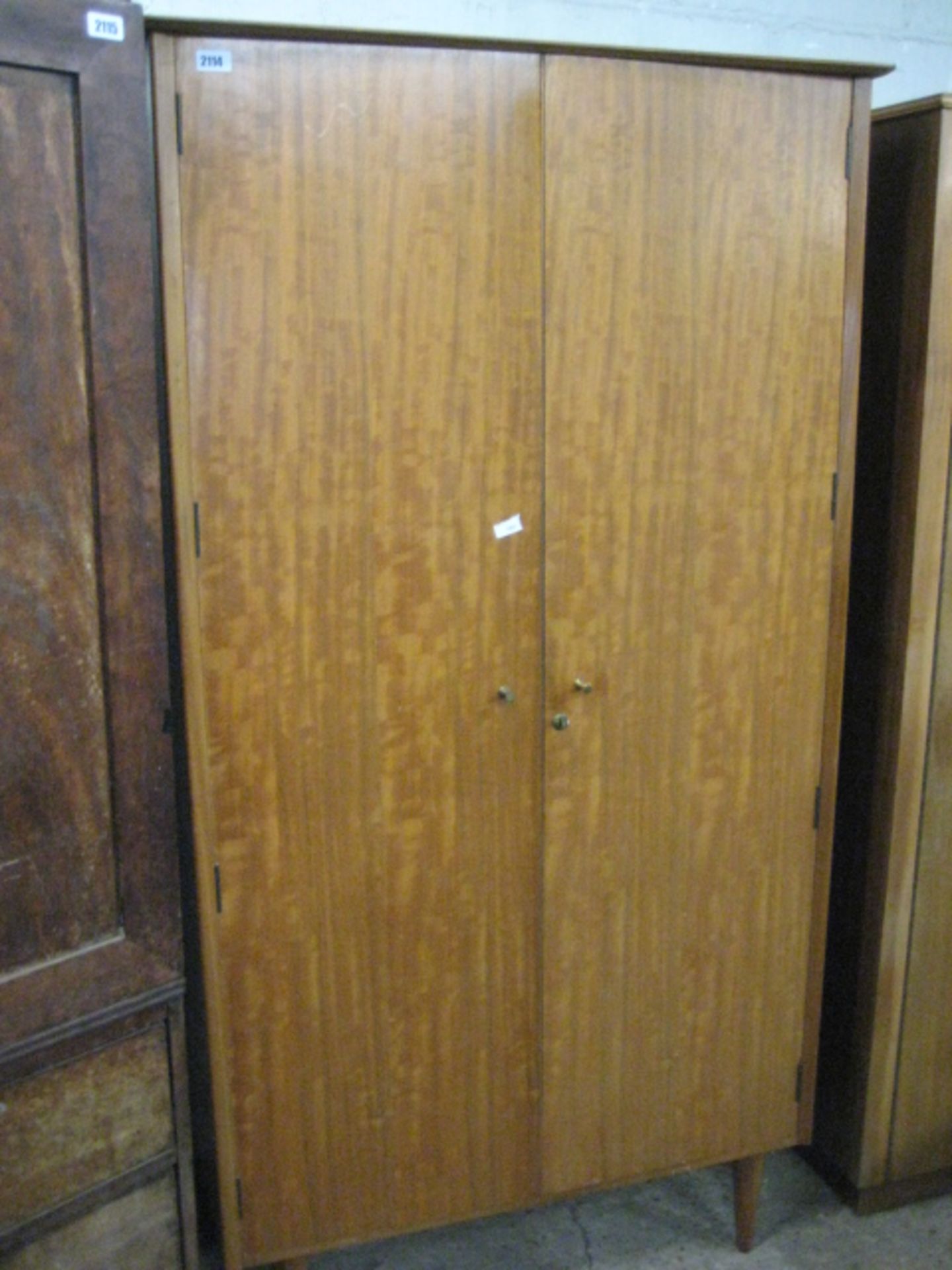 Mid century teak wardrobe raised on tapered legs