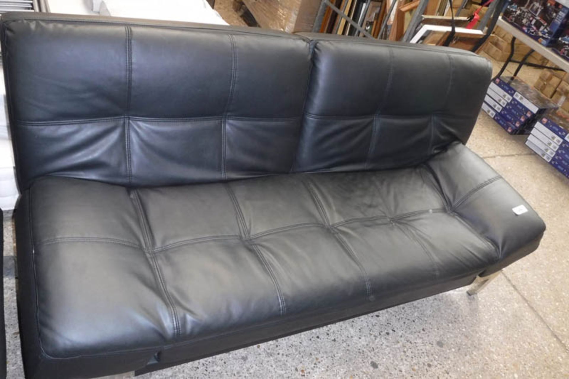 Black leatherette upholstered futon on metal frame