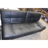 Black leatherette upholstered futon on metal frame