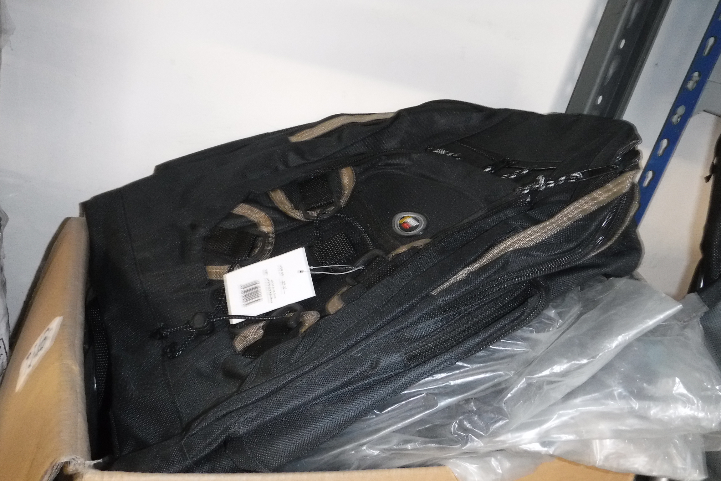 Box containing black rucksacks