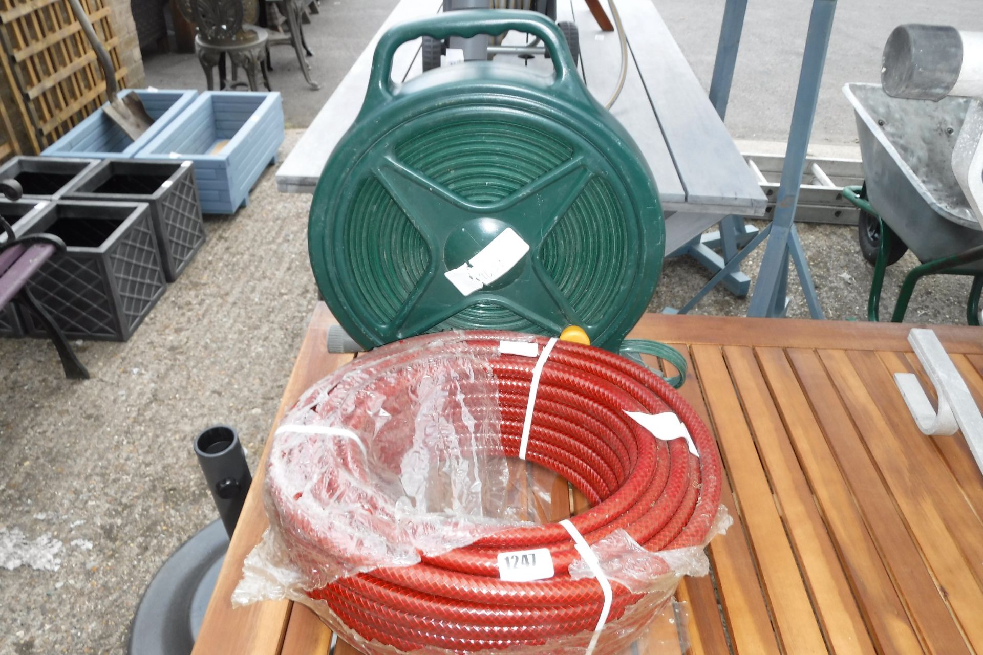 Reel of red garden hose with hose on reel