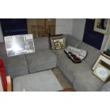 Grey upholstered corner sofa system with matching footstool