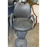 Black leatherette upholstered barbers armchair on single pedestal swivel base