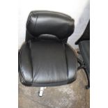 Black upholstered swivel office armchair in parts