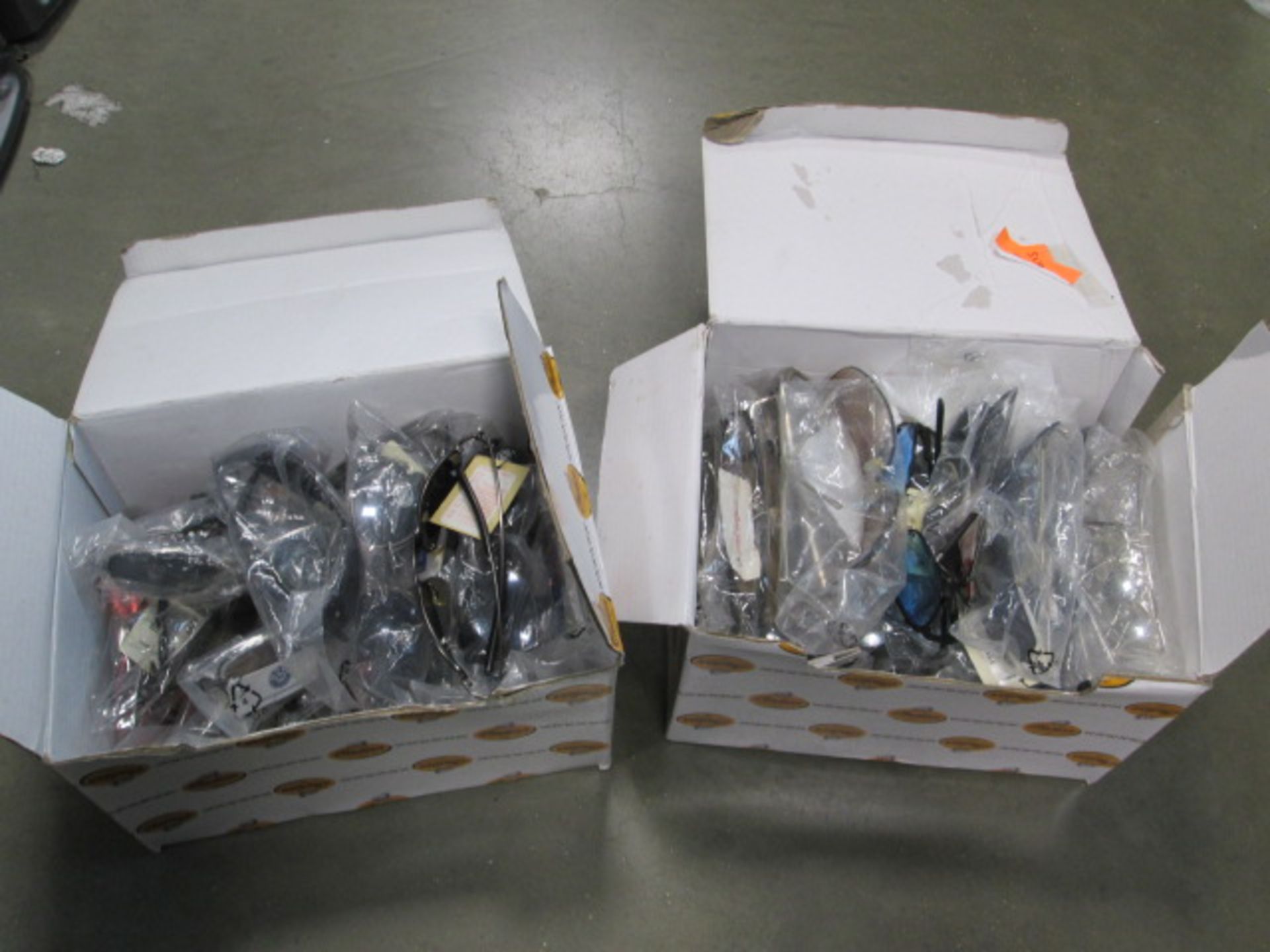 2 boxes containing a quantity of reading glasses and sunglasses