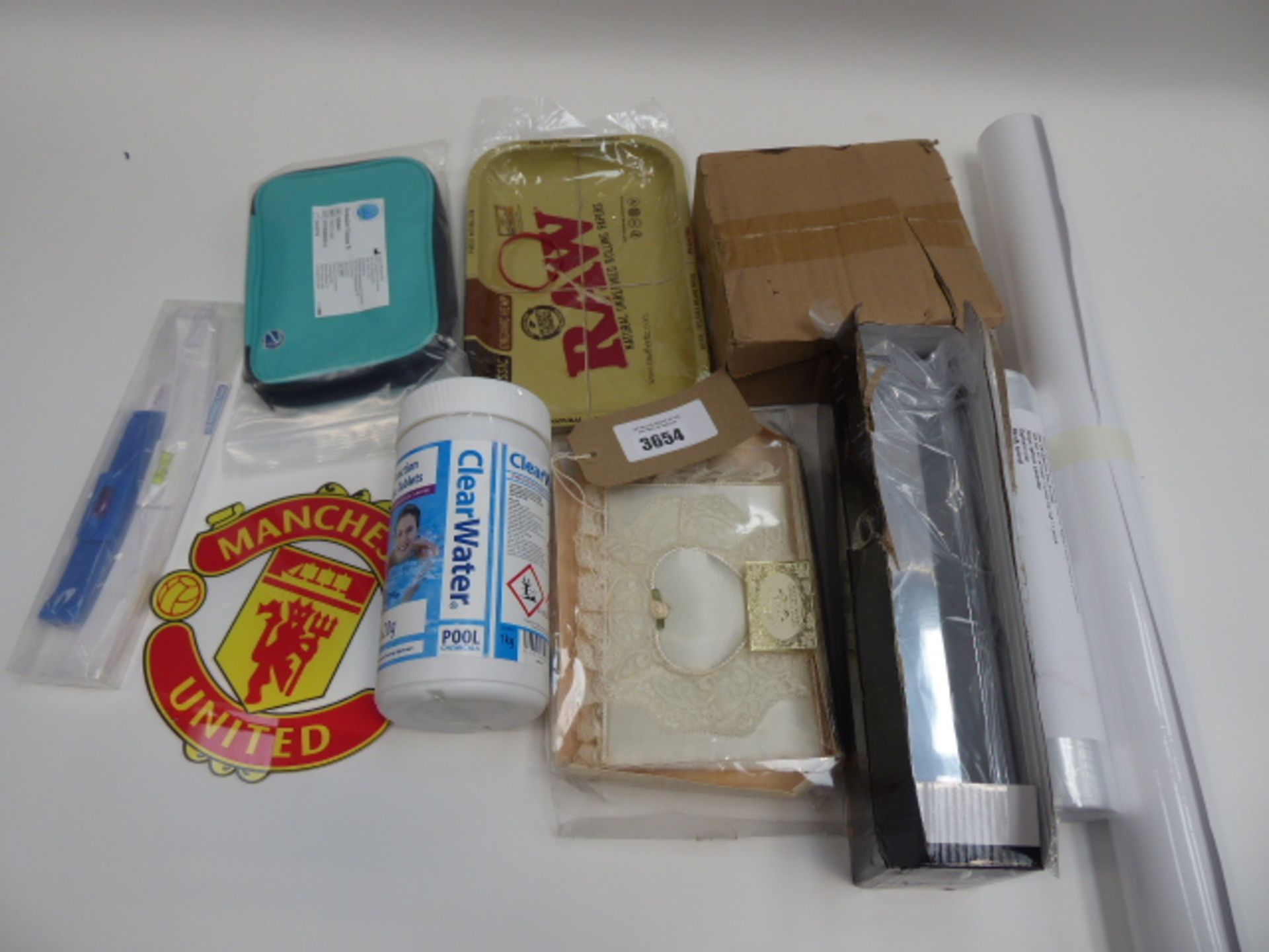 Bag containing RAW rolling tray, Manchester United sign, letter box, ClearWater pool cleaner,