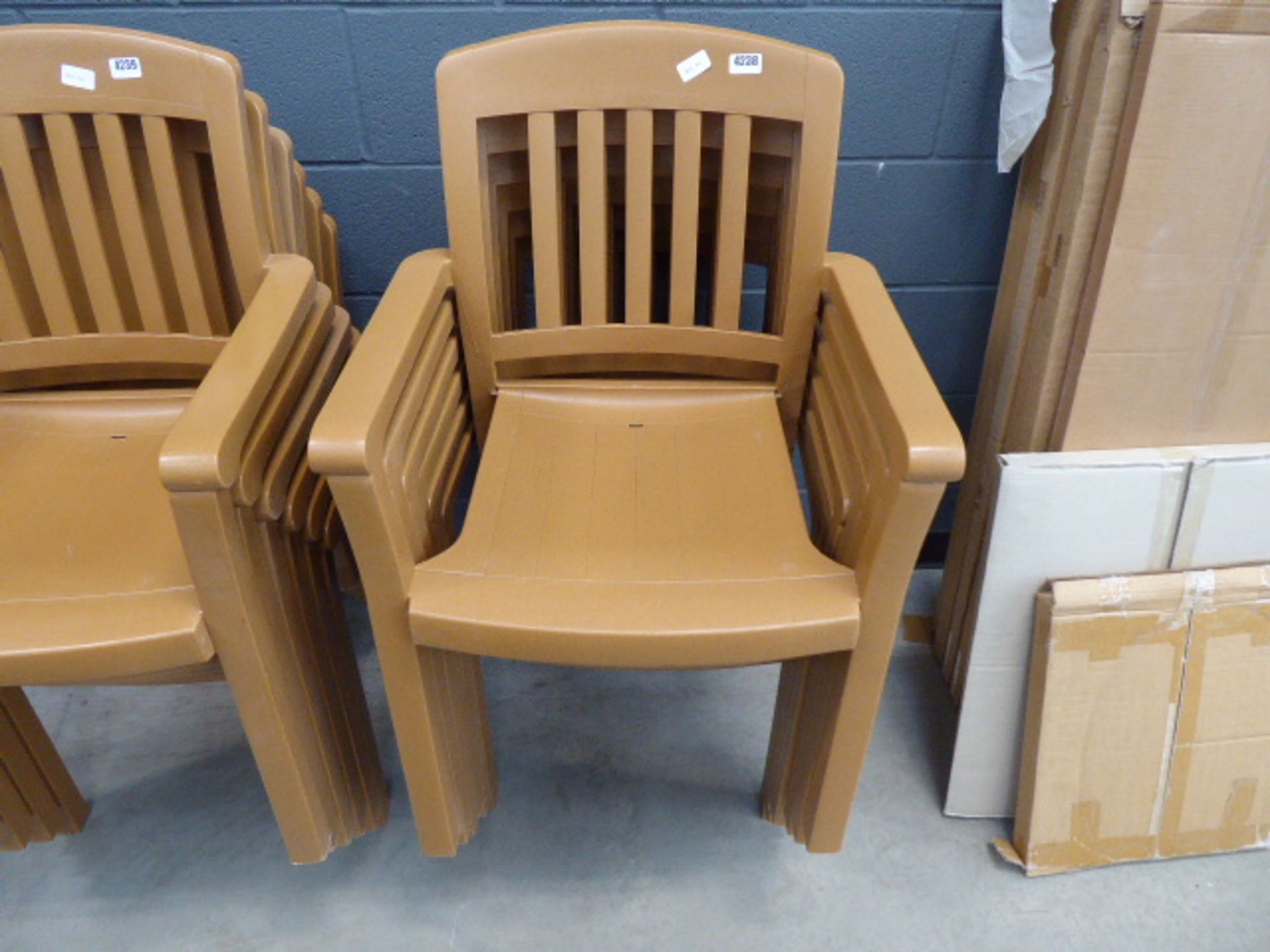 6 brown plastic stacking chairs