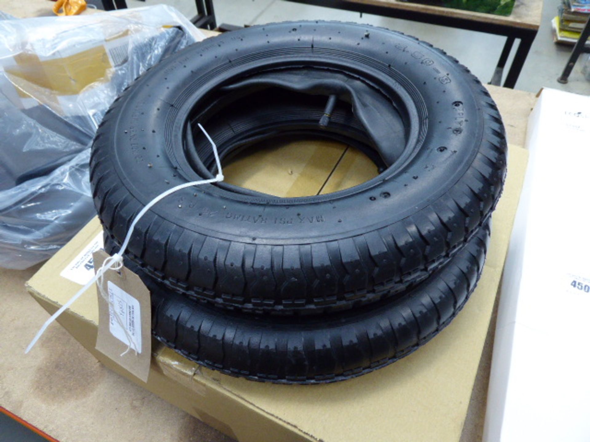 2 wheelbarrow wheels and tyres and box of wheel trims