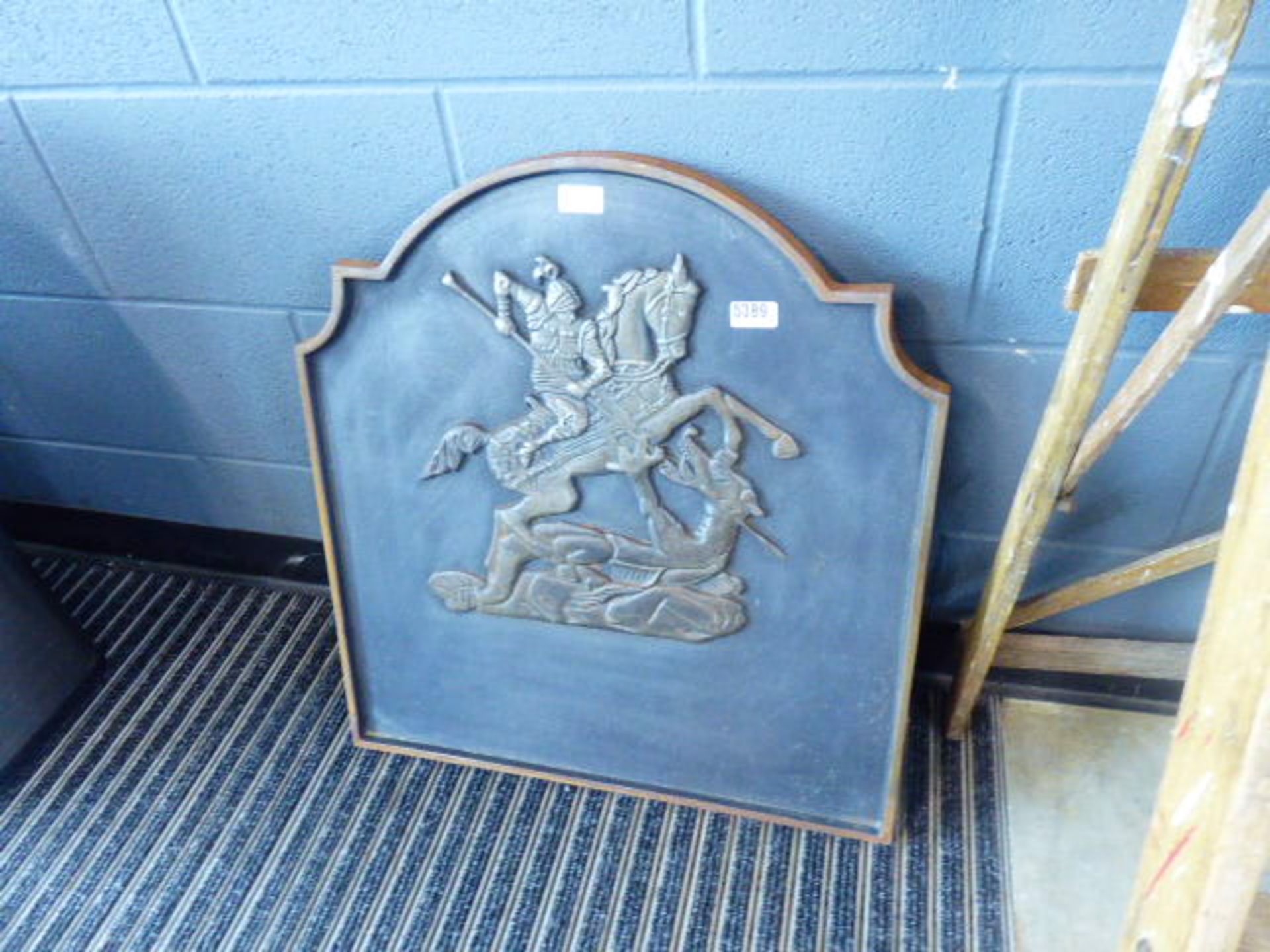 A cast iron fire back with George & the Dragon decoration