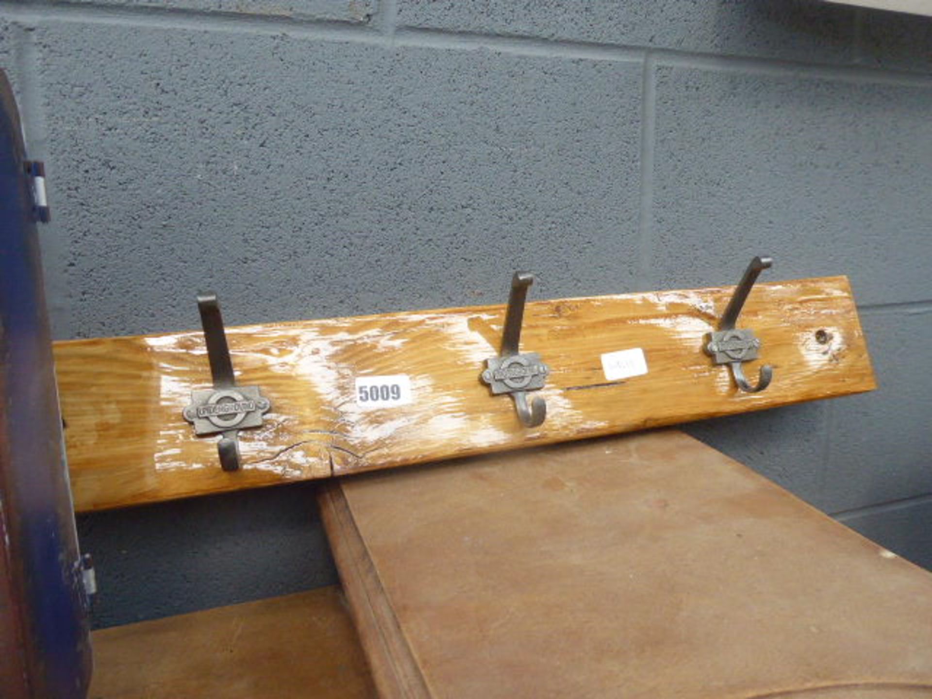 Coat rack with hooks stamped 'Underground'